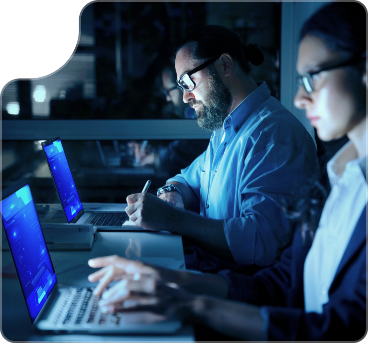 IT professionals collaborating on computers